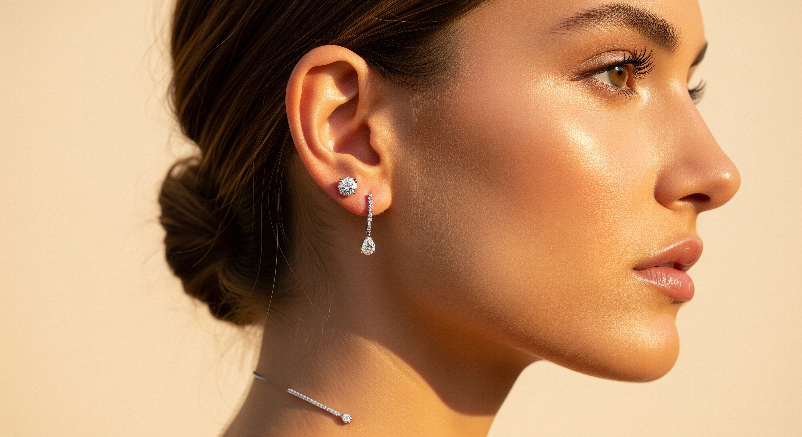 Woman in profile wearing a lab-grown diamond stud and pear-drop earring, editorial portrait