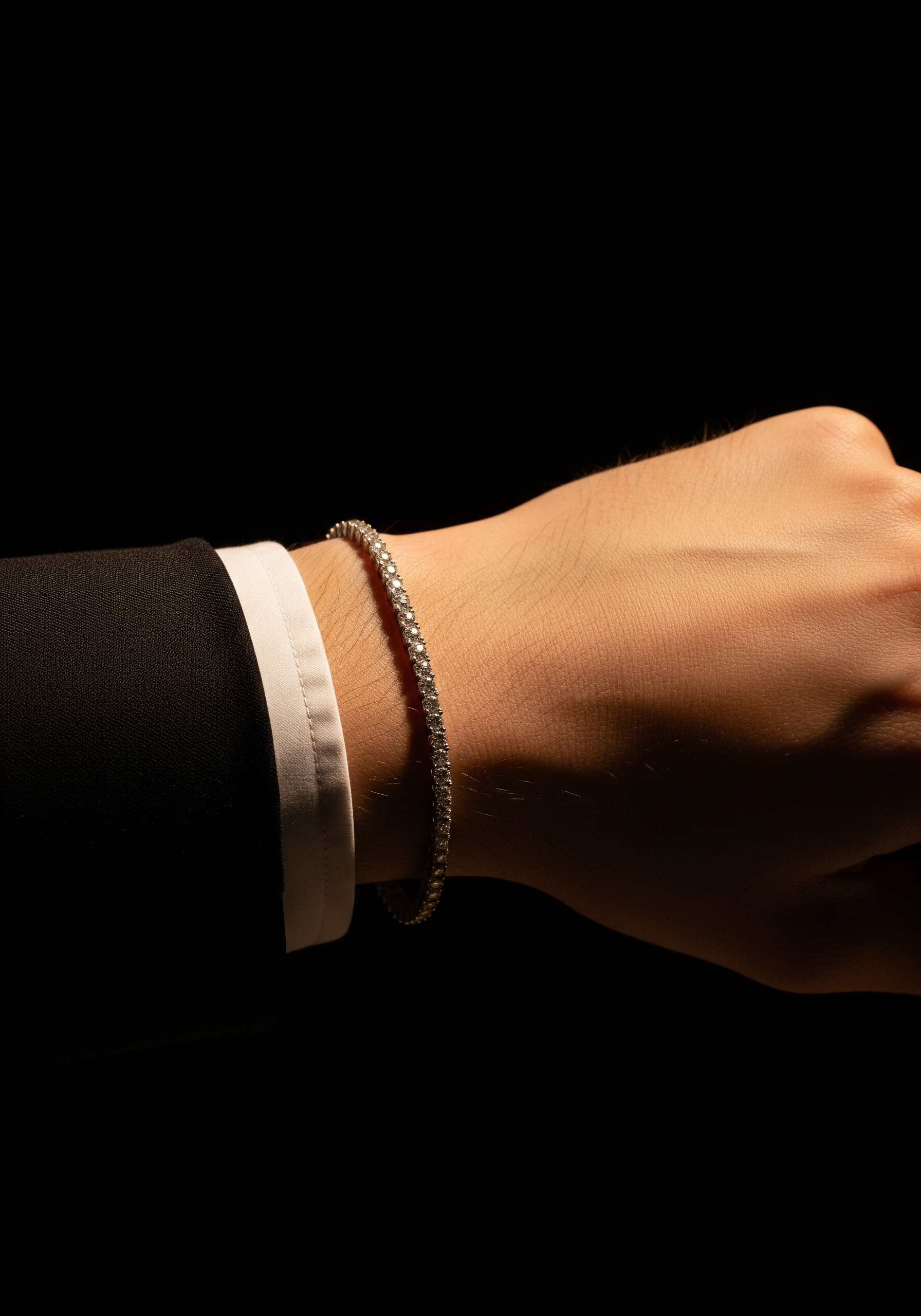 Indian man in slim-fit suit wearing a subtle lab-grown diamond bracelet and stud earring