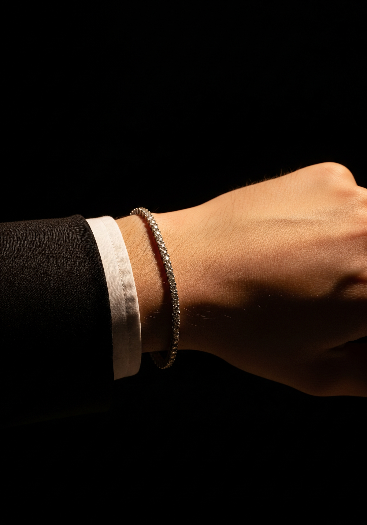 Indian man in slim-fit suit wearing a subtle lab-grown diamond bracelet and stud earring