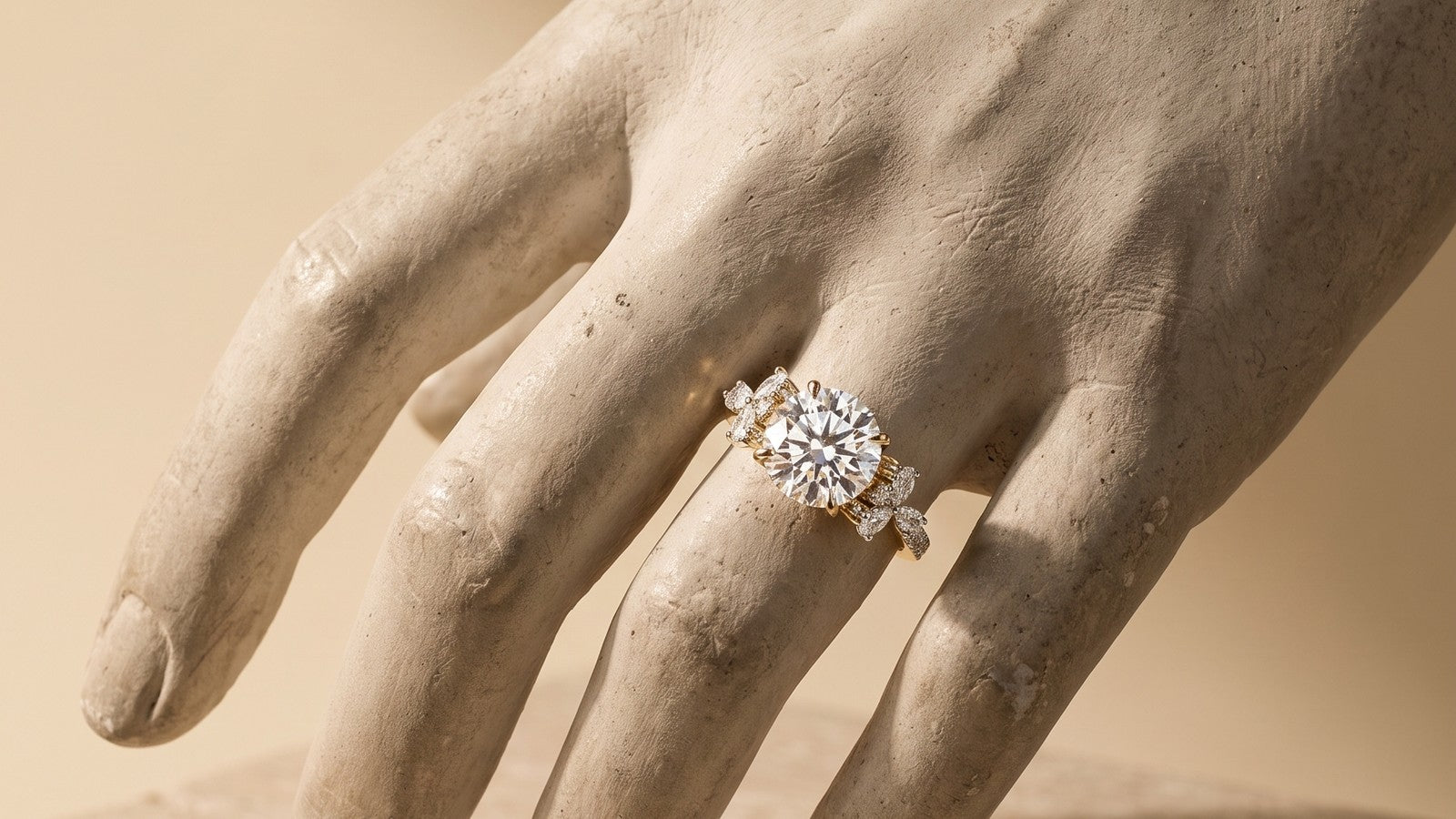 A diamond engagement ring on a sculpted plaster hand