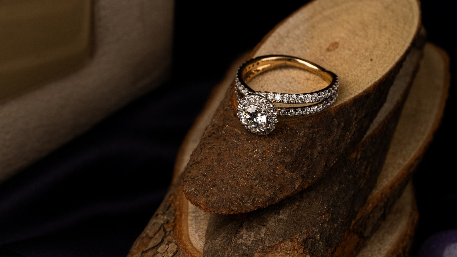 Halo engagement ring stacked with a diamond wedding band in yellow gold