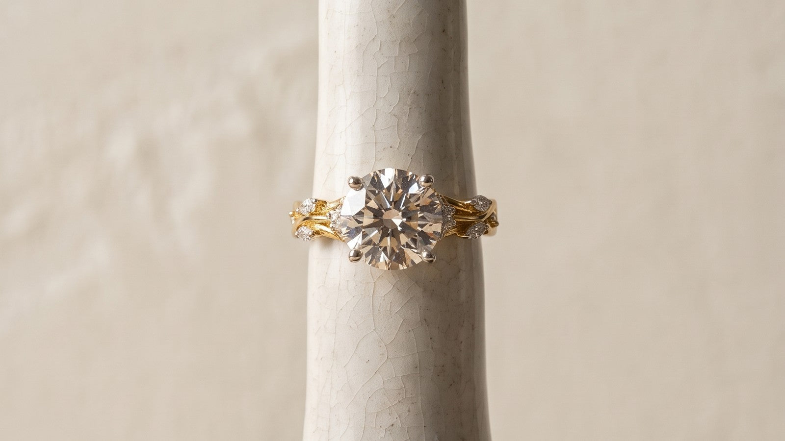 A diamond ring on a ceramic finger form