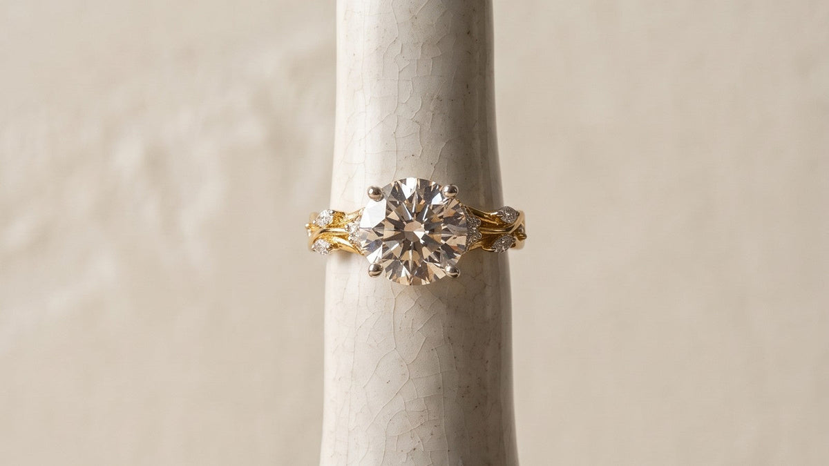 A diamond ring on a ceramic finger form